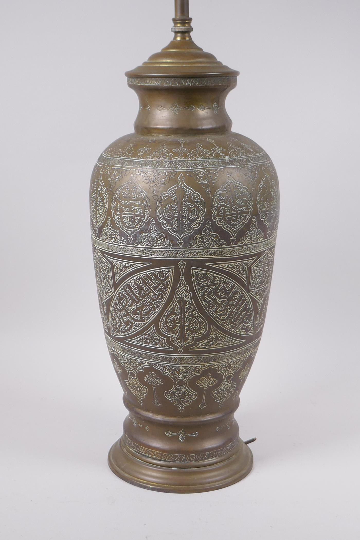 An Islamic brass vase with chased script decoration, converted to a table lamp, 67cm high - Image 2 of 6