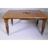 A Victorian mahogany wind out dining table and leaf, on turned and fluted supports, extended 144 x