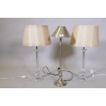 A pair of lucite/acrylic table lamps, 68cm high with shade, and a brushed metal lamp and shade