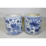 A pair of Chinese blue and white porcelain cylinder jardinieres decorated with carp in a lotus pond,