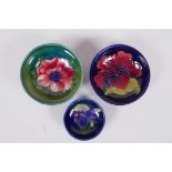 Three Moorcroft pin dishes, Anemone, Hibiscus and Iris, 11cm diameter