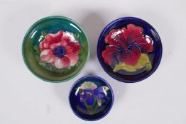 Three Moorcroft pin dishes, Anemone, Hibiscus and Iris, 11cm diameter