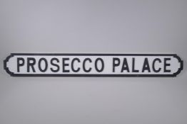 A painted wood sign, Prosecco Palace', the style of a road sign, 105cm long x 14cm high