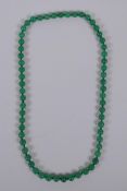 A green hardstone bead necklace, 68cm long