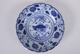 An early C20th Chinese blue and white porcelain bowl with shaped rim, decorated with a carp and