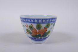 A blue and white porcelain tea bowl with iron red goldfish decoration, Chinese Dao Guang seal mark