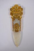 A Chinese archaic style jade carving of a blade, with gilt highlights, 18cm