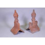 A pair of terracotta roof finial tiles, 60cm high