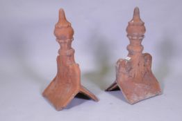 A pair of terracotta roof finial tiles, 60cm high