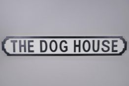 A painted wood sign, 'The Dog House', in the style of a road sign, 88 x 14cm