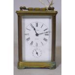 A brass carriage clock with enamel dial and Roman numerals, inscribed John Neal, London, and