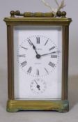 A brass carriage clock with enamel dial and Roman numerals, inscribed John Neal, London, and