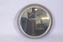 A contemporary metal leaf decorated cushion shaped wall mirror, 68cm diameter