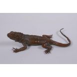 A Japanese style bronze okimono lizard, impressed mark to the base, 15cm long