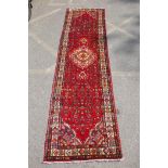 A rich red ground full heavy pile Iranian runner, AF, 104 x 365cm