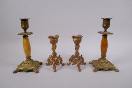 A pair of ormolu rococo style candlesticks, and a pair of gilt bronze and alabaster candlesticks,
