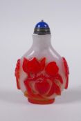 A Chinese Peking glass snuff bottle with raised peach, bat and mythical creature decoration, 7 cm