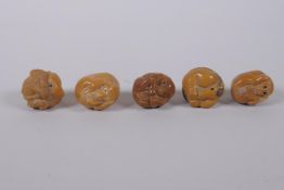 Five Japanese carved tagua nut netsuke in the form of various animals, 3cm diameter