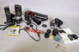 A Pentax SP500 35mm SLR camera, telefoto lens and another, a Dakora 35mm camera, a vintage Kodak