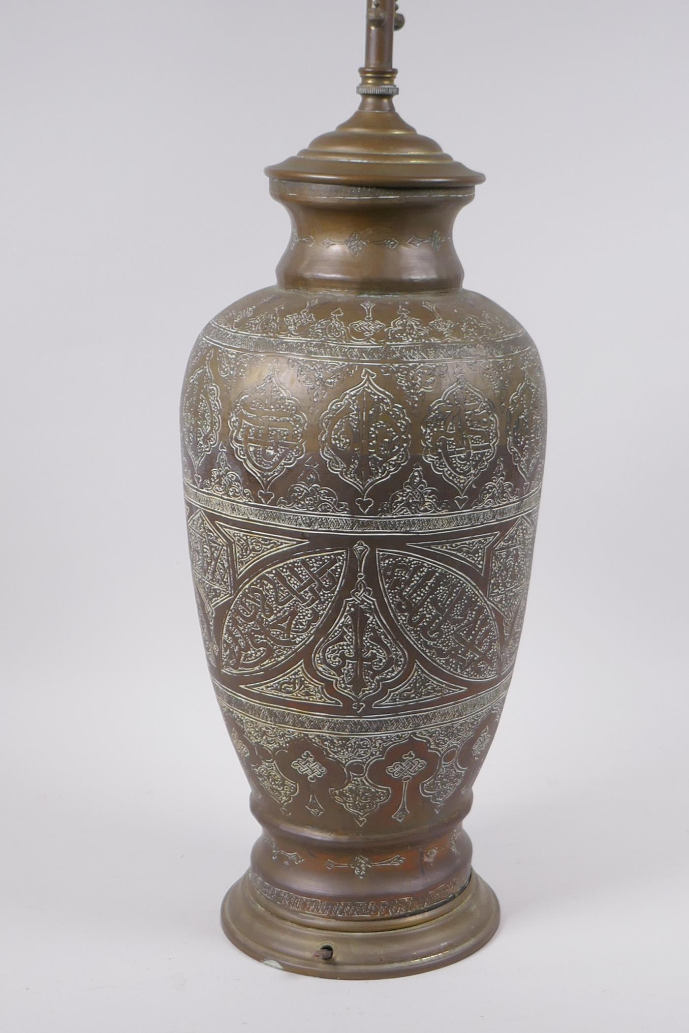 An Islamic brass vase with chased script decoration, converted to a table lamp, 67cm high - Image 3 of 6