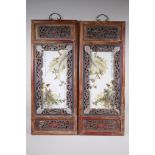 A pair of early C20th Chinese polychrome porcelain panels decorated with birds amongst flowers,