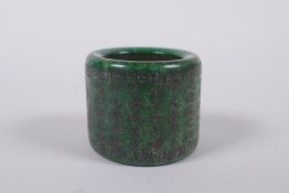 A Chinese marbled green hardstone archers thumb ring, decorated with an allover character