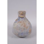 An Islamic blue glazed earthenware pourer with bearded face decoration