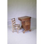 A Victorian pitch pine desk, with pen tray and inkwell, lift up top and side flap and door to