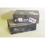 A vintage metal strapped travel trunk adorned with various cabin labels, together with a large metal