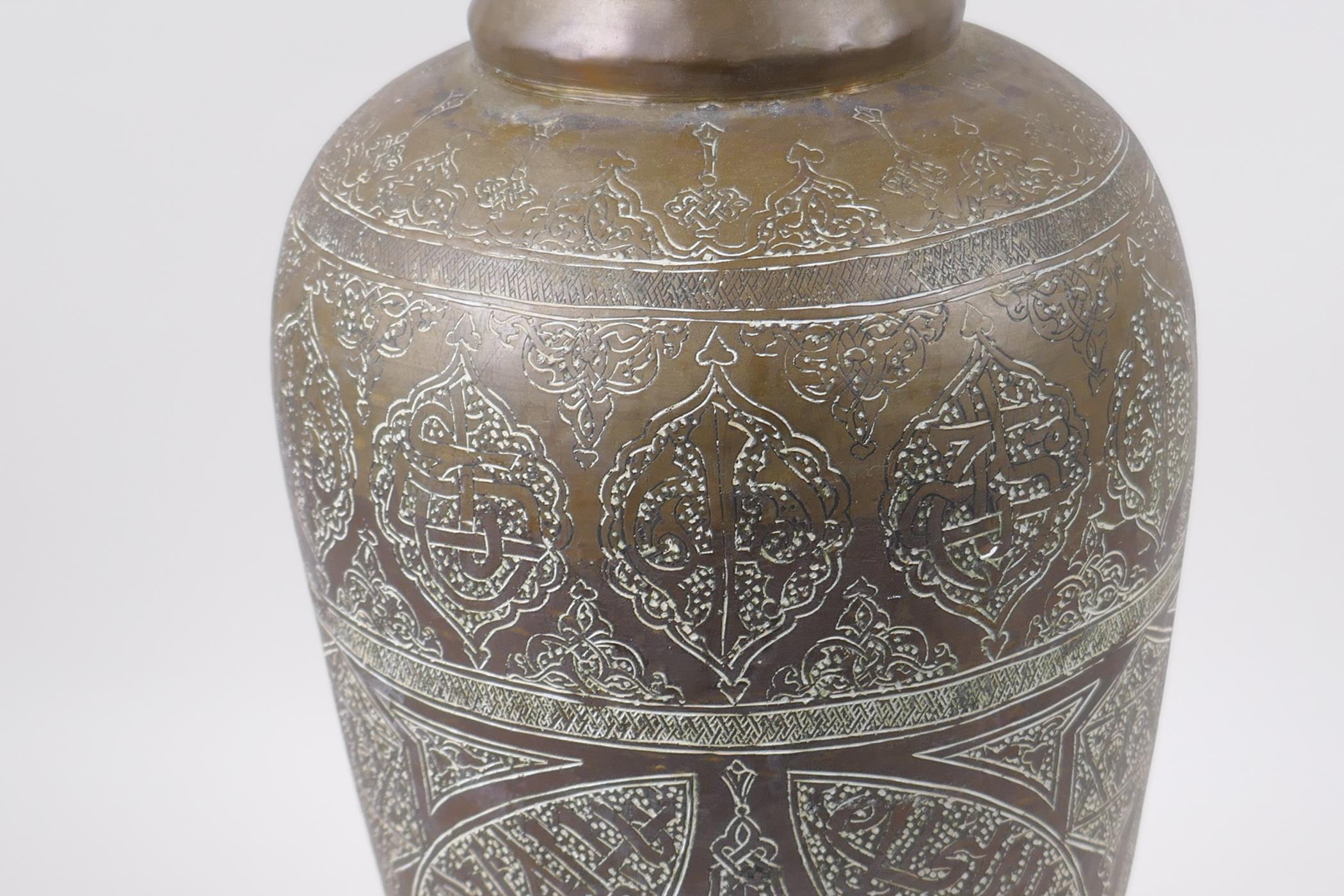 An Islamic brass vase with chased script decoration, converted to a table lamp, 67cm high - Image 6 of 6