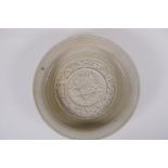 A Chinese celadon ground porcelain dish, the bowl with raised decoration of the animals of the
