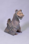 A terracotta ridge tile in the form of a gargoyle, 48cm high