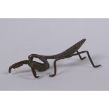 A Japanese style bronze okimono in the form of a mantis, 8cm long