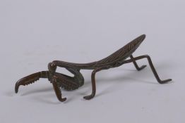 A Japanese style bronze okimono in the form of a mantis, 8cm long