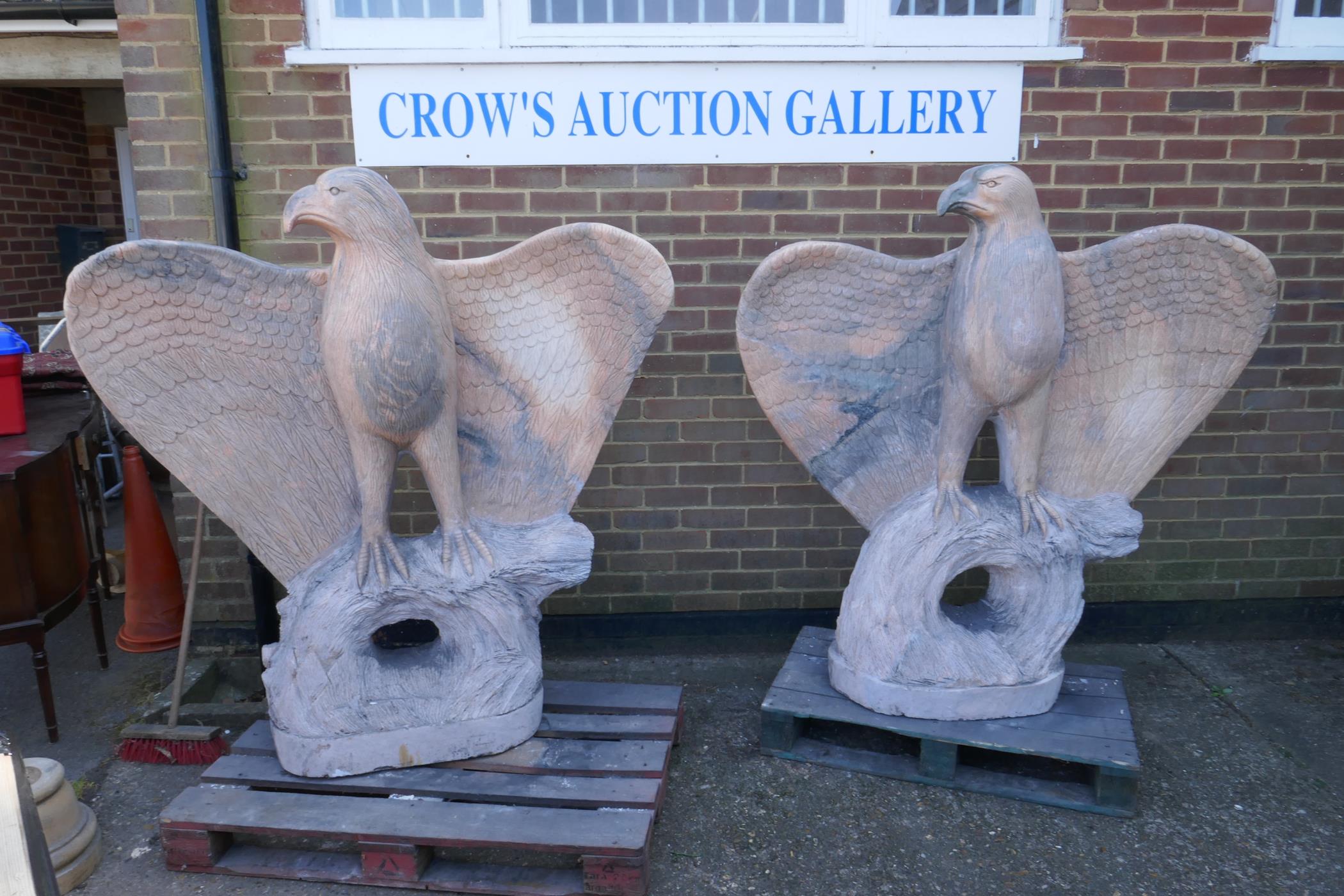 A pair of monumental carved marble eagles, 152cm high