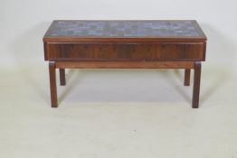 A mid century rosewood two drawer side table, with inset tile top, 92 x 42 x 44cm