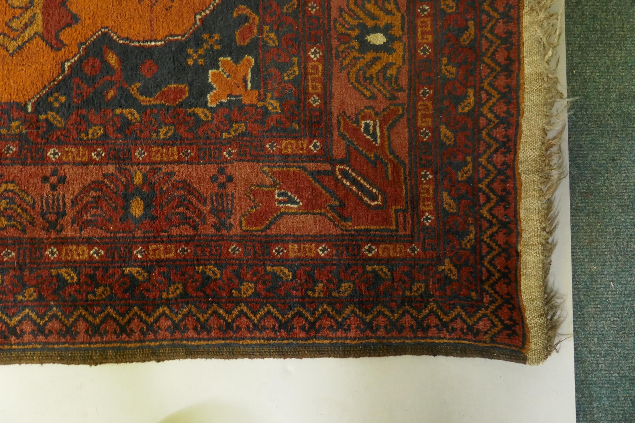 An antique oriental red ground wool runner decorated with geometric floral medallions and birds, - Image 4 of 5