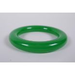 A Chinese apple jade bangle, 8cm diameter