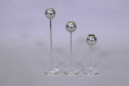 A set of three graduated chrome metal WMF candle holders, tallest 25cm high