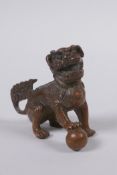A Chinese bronze figure of a fo-dog, 6cm high