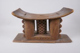 An African Ashanti carved wood headrest/stool, first half of the C20th, repairs, 44 x 16cm, 24cm