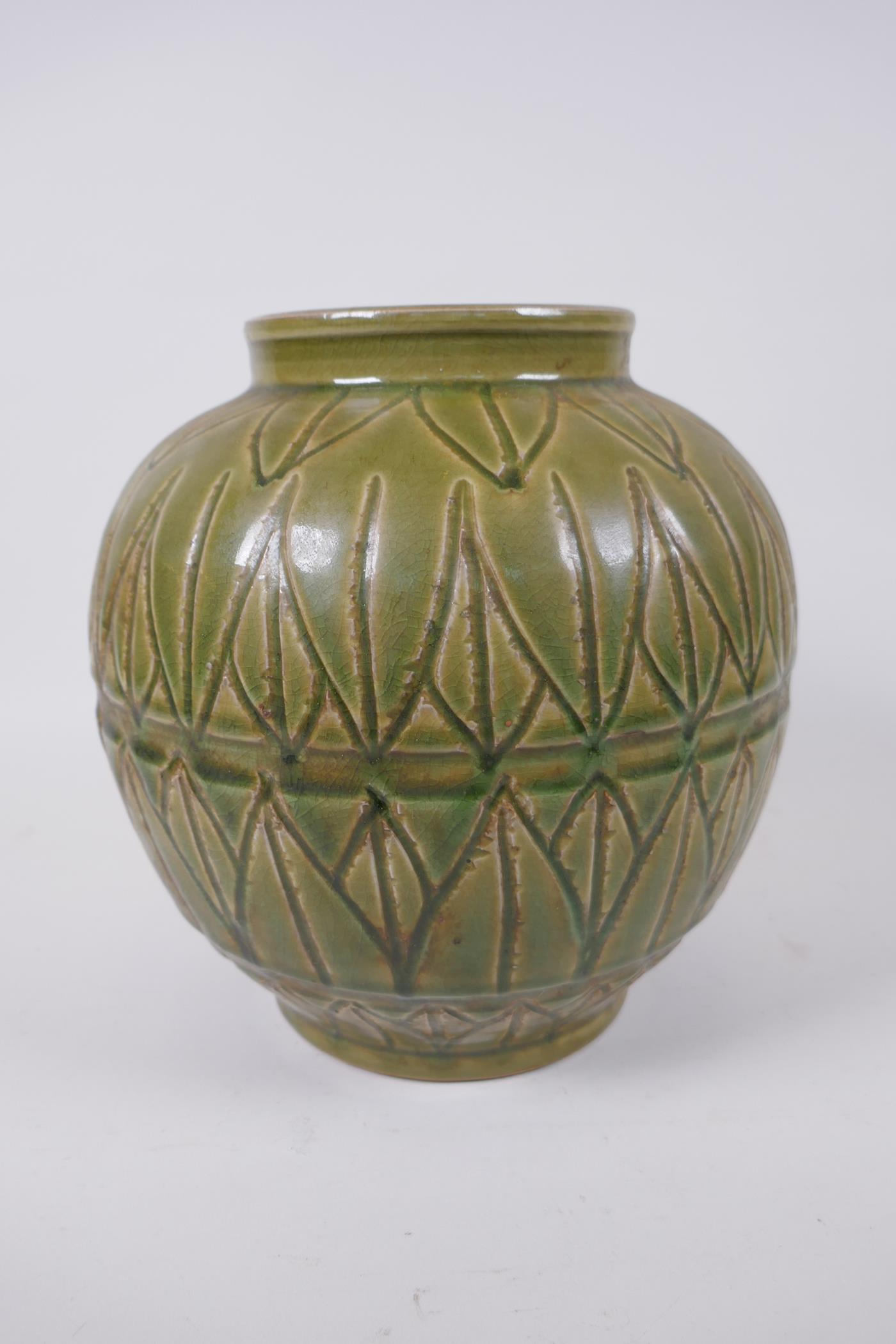 An oriental olive glazed porcelain jar with incised lotus leaf decoration, 23cm high
