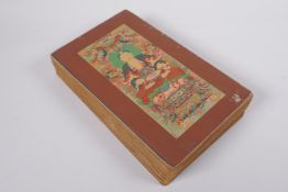 A Sino Tibetan printed concertina book depicting assorted thangkas, 17 x 28cm