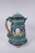 A C19th continental Majolica jug and cover with lion mask decoration, signed and dated 1872 to the