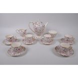 An Arklow pottery six piece tea set with a transfer printed rose decoration, one teacup different,