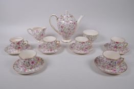 An Arklow pottery six piece tea set with a transfer printed rose decoration, one teacup different,