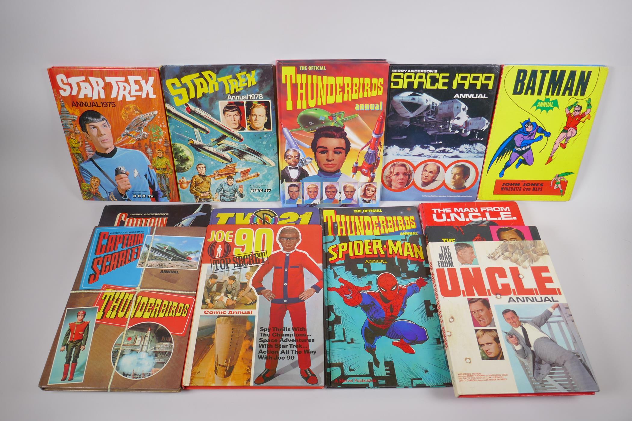 An assorted collection of retro British children's TV annuals including Thunderbirds, Captain