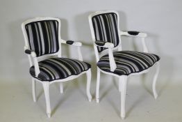 A pair of Louis XV style painted open arm chairs