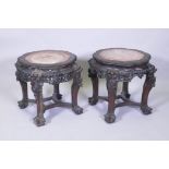 A pair of C19th Chinese hardwood tables/stands, with inset rouge marble tops, carved and pierced