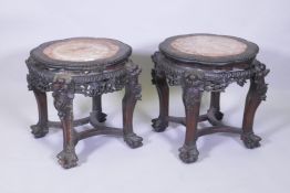 A pair of C19th Chinese hardwood tables/stands, with inset rouge marble tops, carved and pierced